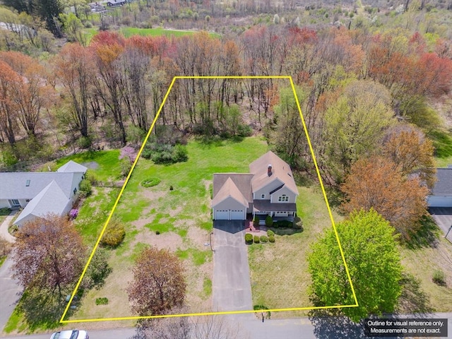drone / aerial view featuring a wooded view