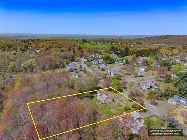 birds eye view of property featuring a residential view and a wooded view