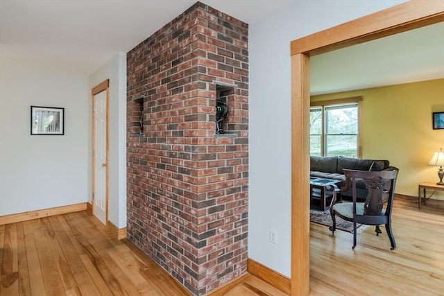 hall with baseboards and hardwood / wood-style flooring