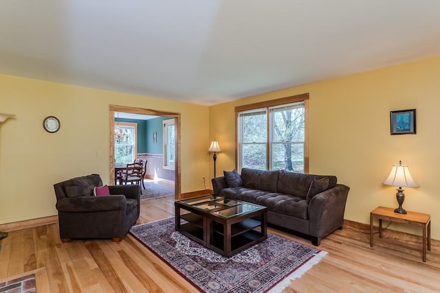 living area with baseboards and light wood-style flooring