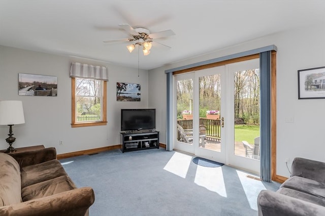 living room with baseboards, a ceiling fan, carpet, and visible vents