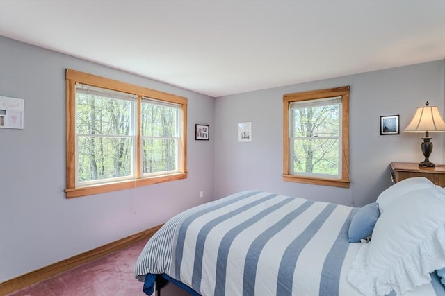 carpeted bedroom with baseboards