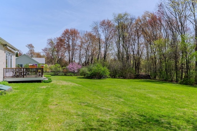 view of yard featuring a deck and fence