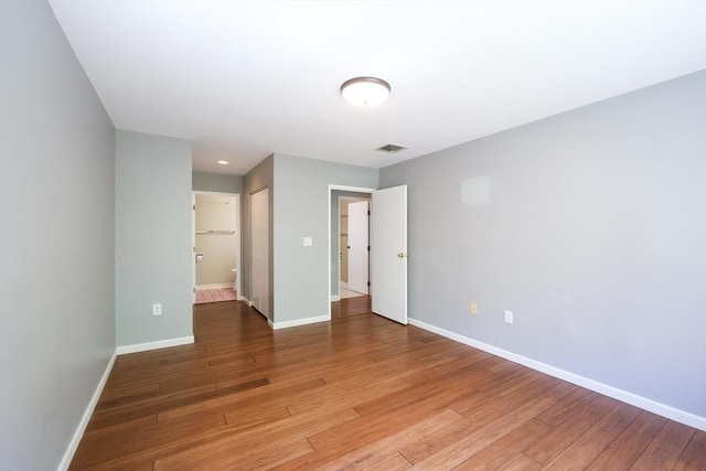 unfurnished room with baseboards and light wood finished floors