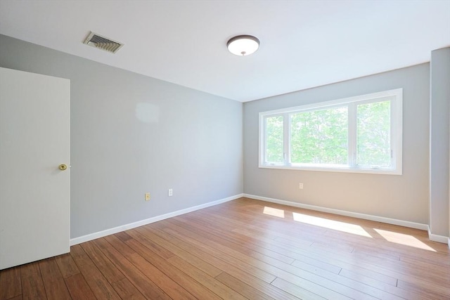 empty room with light wood-type flooring and baseboards
