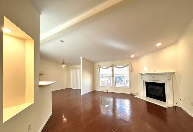 unfurnished living room featuring crown molding, vaulted ceiling, and dark hardwood / wood-style flooring