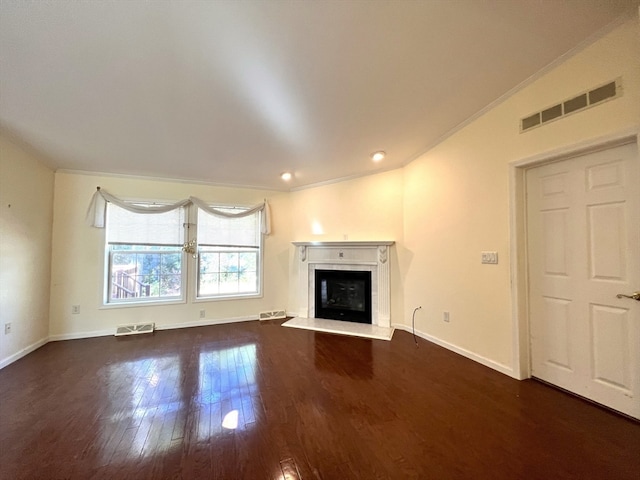 unfurnished living room featuring ornamental molding and dark hardwood / wood-style flooring