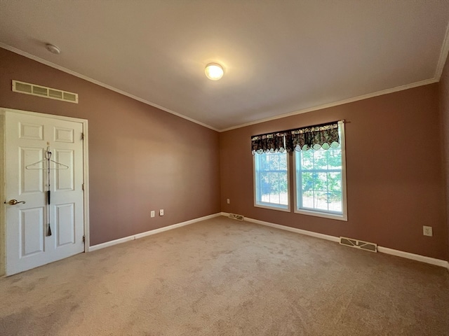 carpeted spare room with ornamental molding and vaulted ceiling