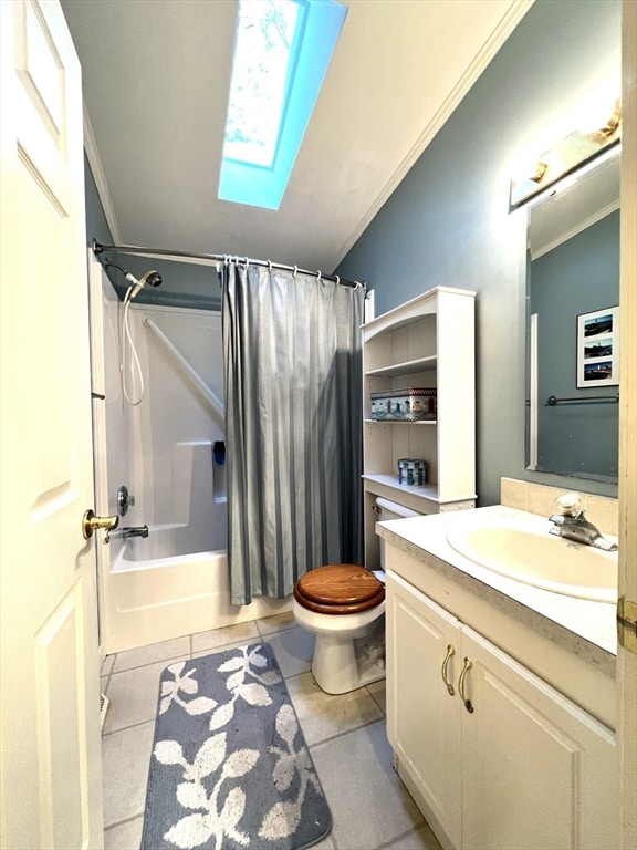 full bathroom featuring shower / bath combination with curtain, toilet, vaulted ceiling with skylight, vanity, and ornamental molding