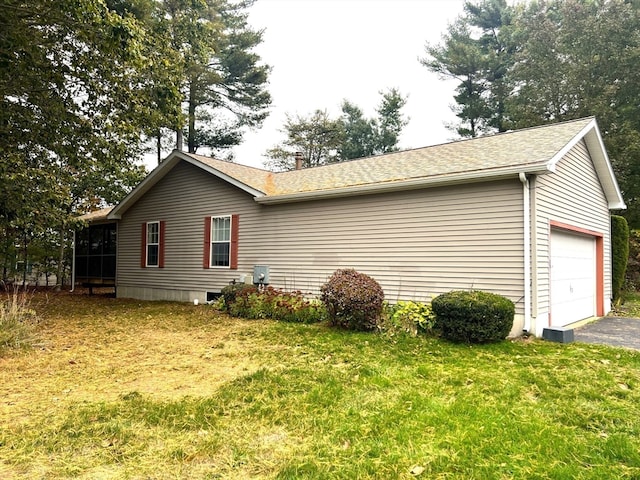 view of home's exterior featuring a garage and a lawn