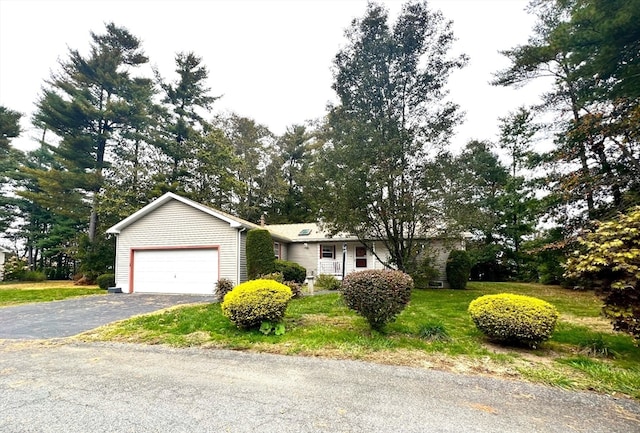 ranch-style home with a front lawn and a garage