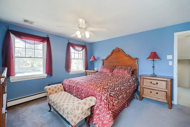 carpeted bedroom with visible vents, a ceiling fan, and a baseboard radiator