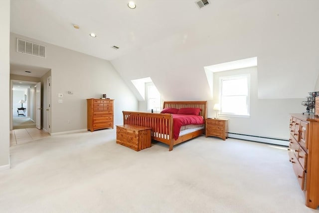 bedroom featuring a baseboard heating unit, light carpet, lofted ceiling, and visible vents