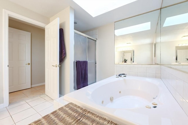 bathroom with a skylight, a tub with jets, a stall shower, and tile patterned floors