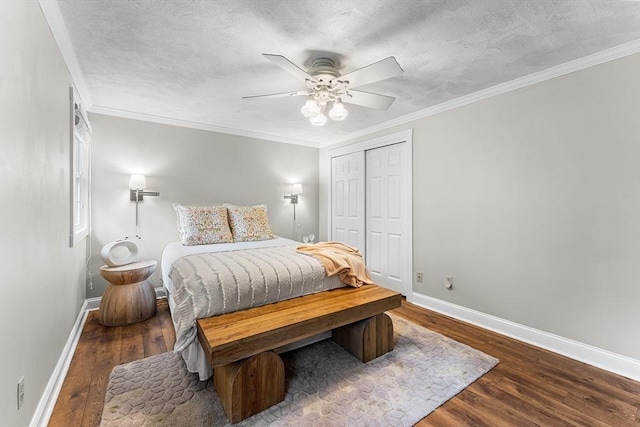 bedroom featuring a textured ceiling, crown molding, baseboards, and wood finished floors