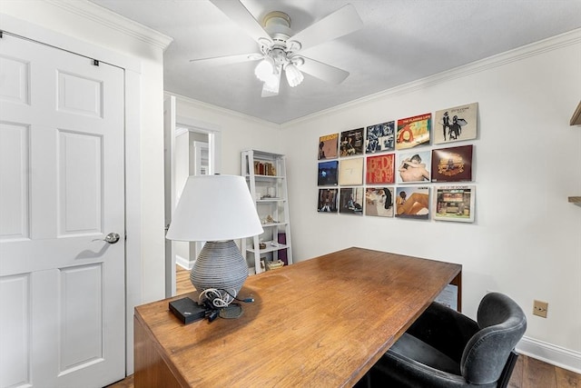 office with baseboards, crown molding, a ceiling fan, and wood finished floors