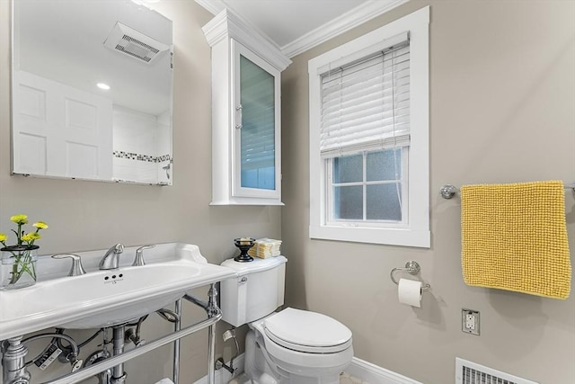 bathroom with crown molding, toilet, baseboards, and visible vents