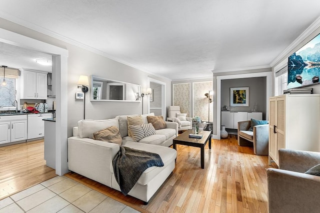 living room with ornamental molding and light wood finished floors