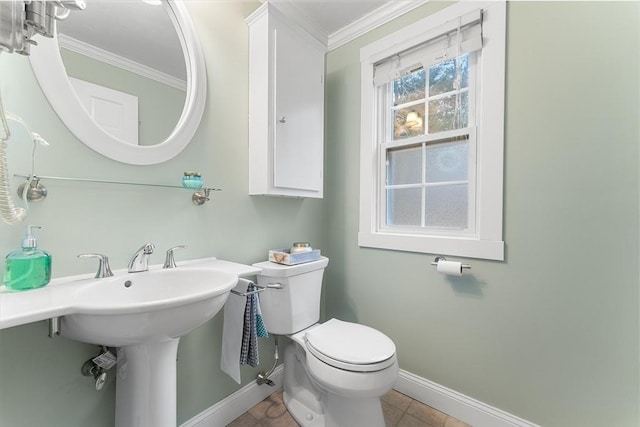 bathroom featuring tile patterned floors, toilet, baseboards, and ornamental molding