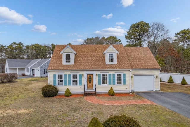 new england style home with a garage and a front lawn