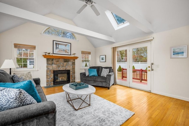 living room with hardwood / wood-style flooring, plenty of natural light, ceiling fan, and a fireplace