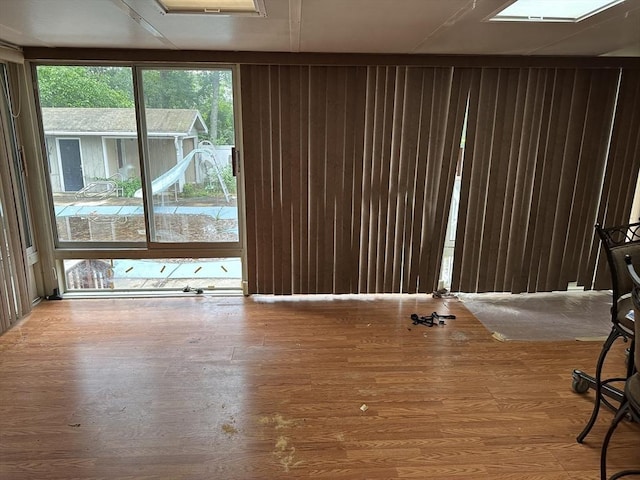 55 Alexander Ave, Dracut, MA 01826 - unfurnished living room with wood walls and wood finished floors