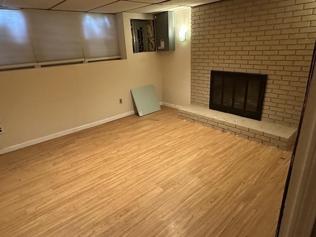55 Alexander Ave, Dracut, MA 01826 - finished basement with a paneled ceiling, wood finished floors, and a fireplace