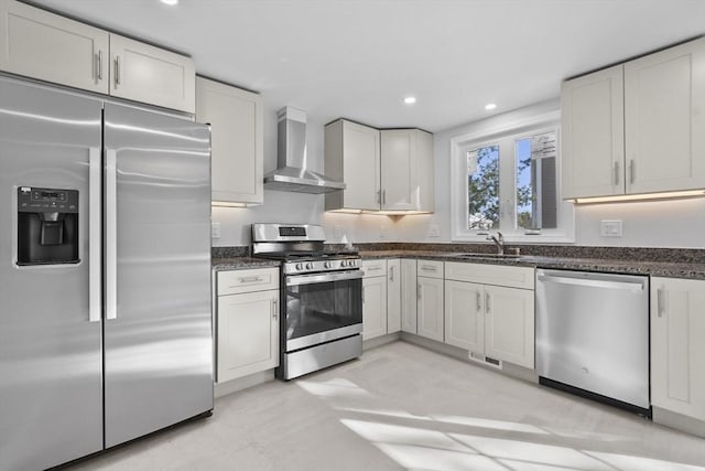 kitchen with stainless steel appliances, white cabinetry, and wall chimney exhaust hood