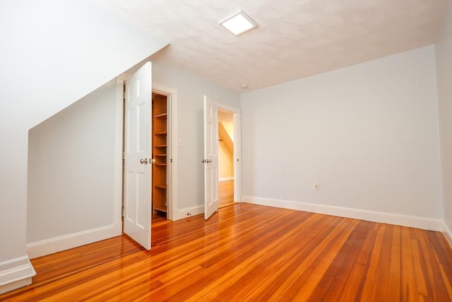 2A Hazel St Unit 3, Salem, MA 01970 - unfurnished bedroom featuring light wood-type flooring, baseboards, a closet, and a spacious closet