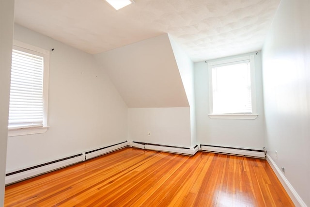 2A Hazel St Unit 3, Salem, MA 01970 - additional living space with a baseboard heating unit, plenty of natural light, and light wood-type flooring