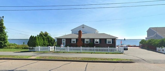 view of front of property with a water view