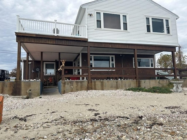 view of front facade with a balcony and a porch