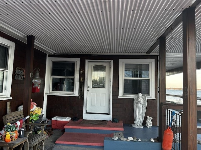 property entrance featuring a porch and a water view