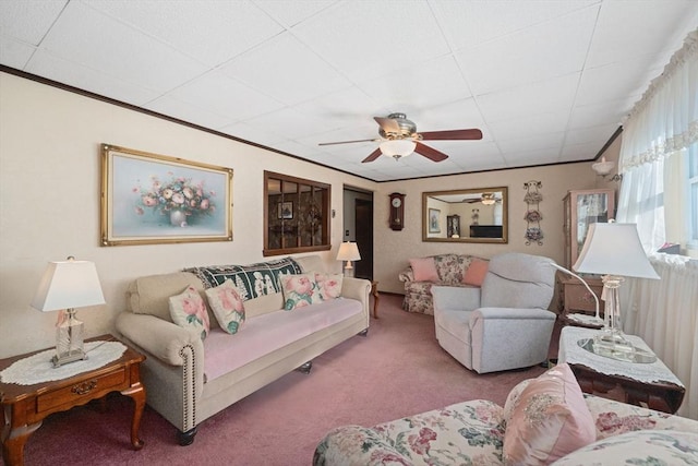 living room with ornamental molding, ceiling fan, and carpet