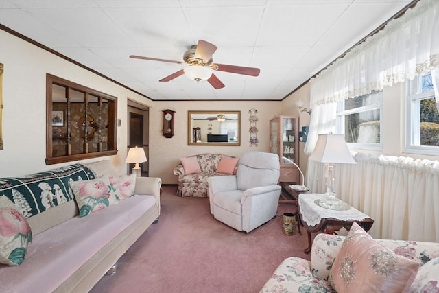 living room with crown molding, ceiling fan, and carpet