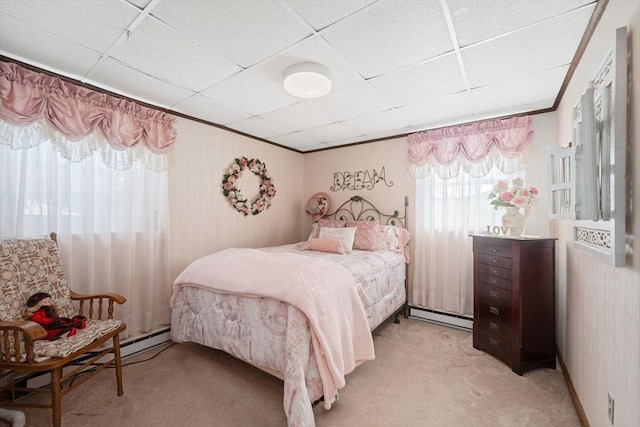 carpeted bedroom with crown molding, a baseboard radiator, and a paneled ceiling