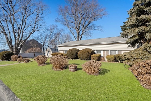 view of property exterior with a yard