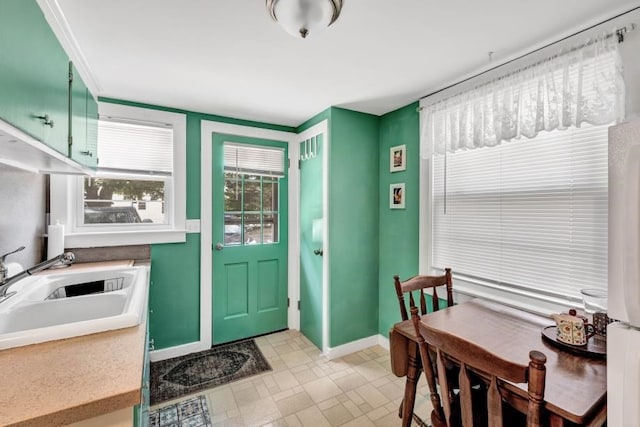 kitchen featuring sink and green cabinetry