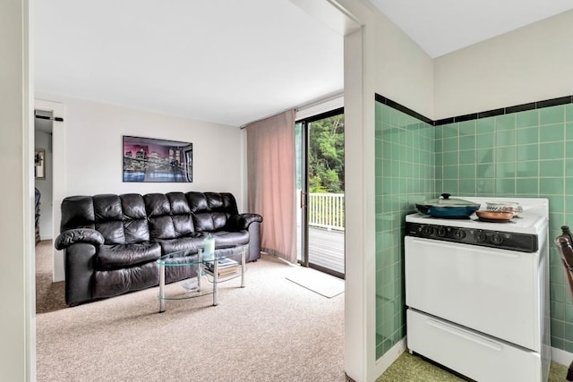 carpeted living room featuring tile walls