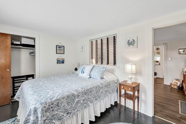 bedroom with a closet and dark hardwood / wood-style floors