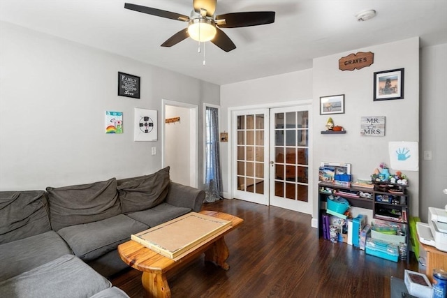 living area with a ceiling fan, wood finished floors, and french doors