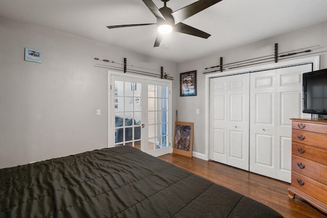 unfurnished bedroom with baseboards, a ceiling fan, wood finished floors, french doors, and a closet