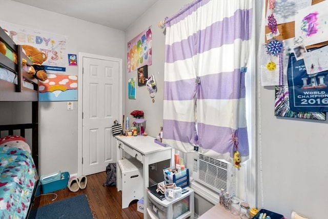 bedroom featuring dark hardwood / wood-style flooring and cooling unit