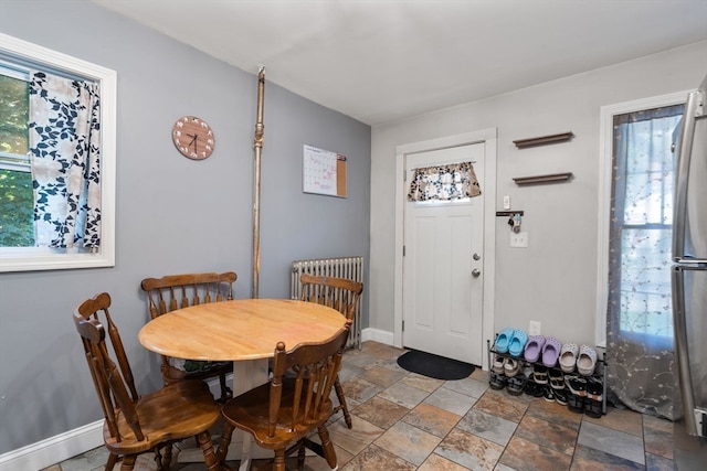 dining space with radiator and plenty of natural light