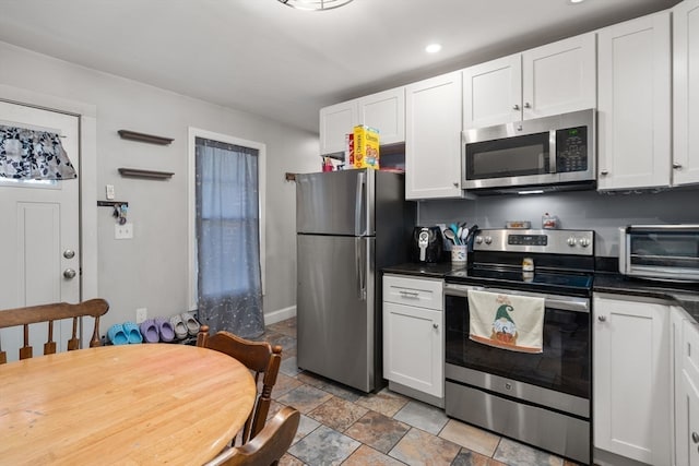 kitchen with appliances with stainless steel finishes and white cabinetry