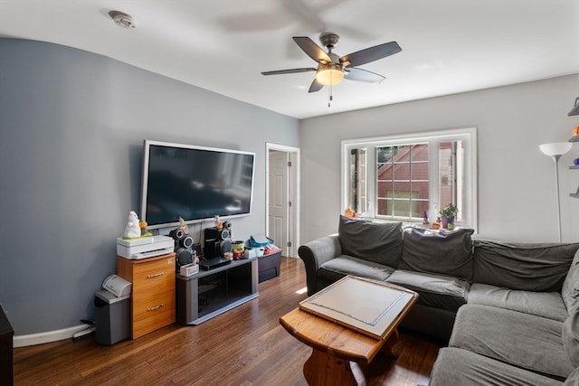 living room featuring ceiling fan and dark hardwood / wood-style floors