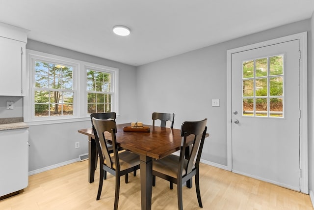 dining space with plenty of natural light and light wood-type flooring