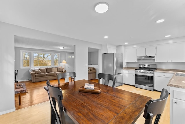 dining room with light hardwood / wood-style flooring and sink