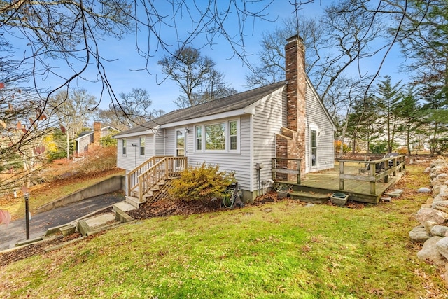 view of home's exterior featuring a lawn and a wooden deck