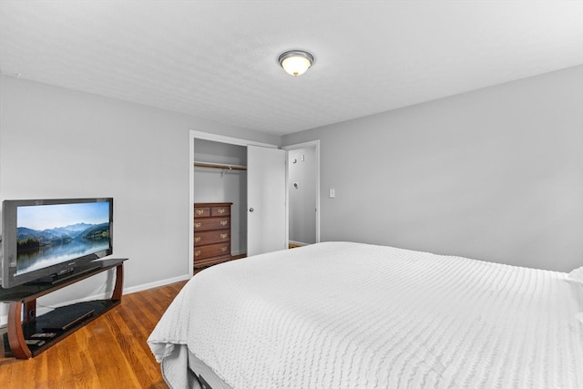 bedroom featuring dark hardwood / wood-style flooring and a closet